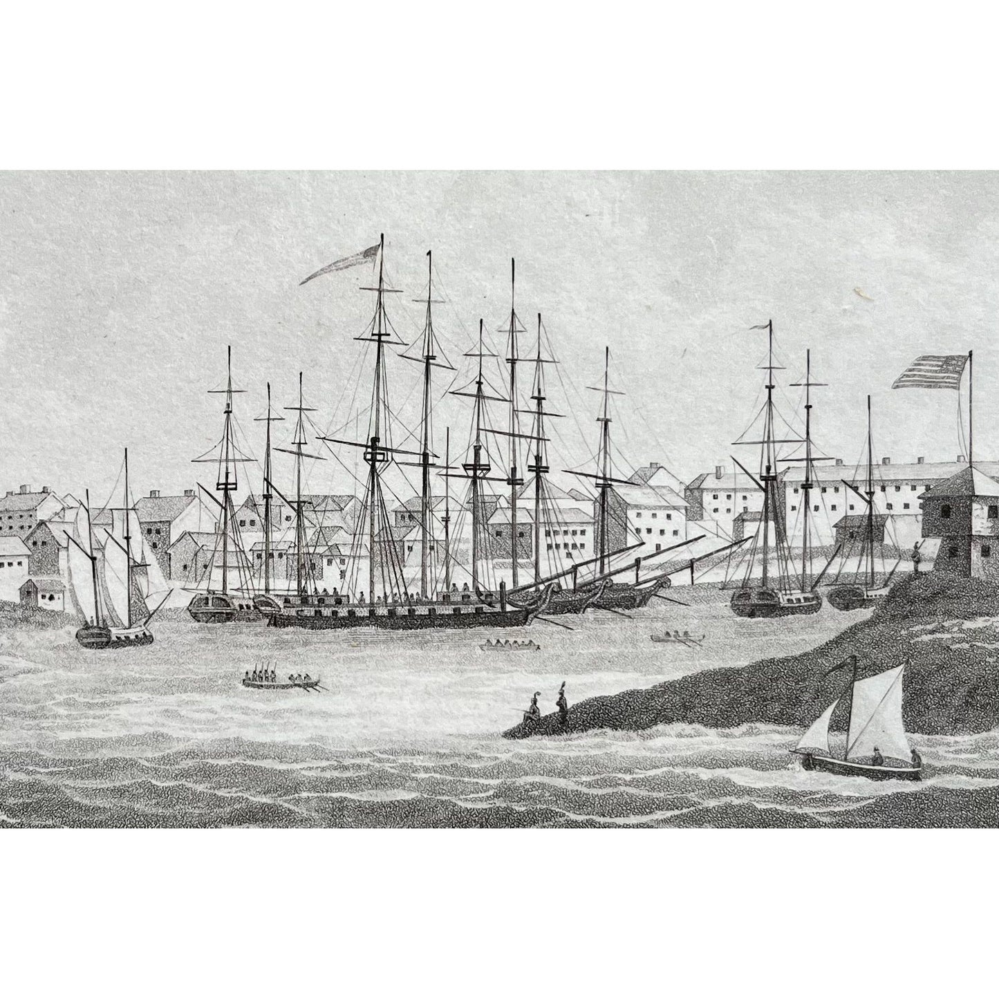 Black and white matted print of Sackett’s Harbour on Lake Ontario with ships and soldiers, American flags, troops and more, for sale by Victoria Cooper Antique Prints